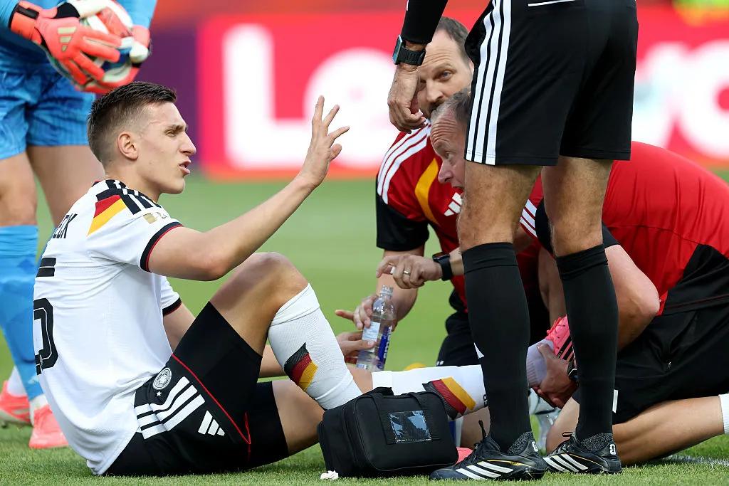 The crutches by the bench, the ice packs on the floor — behind the curtain of Germany's injury crisis, a team doctor fights to keep a dream alive